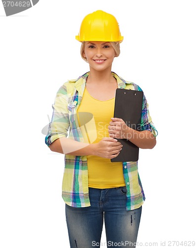 Image of smiling woman in helmet with clipboard