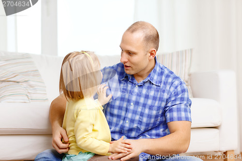 Image of smiling father and daughter playing at home