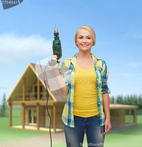 Image of smiling woman with drill machine