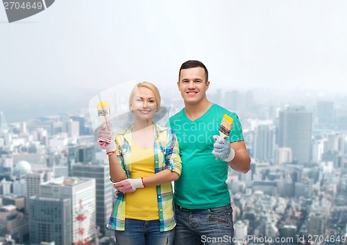 Image of smiling couple with paintbrush