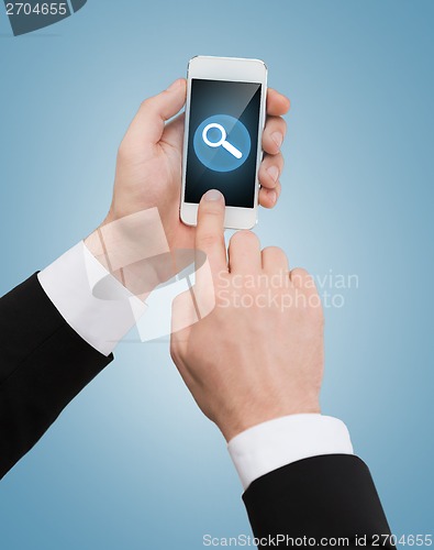 Image of businessman touching screen of smartphone