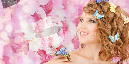 Image of happy teenage girl with butterflies in hair