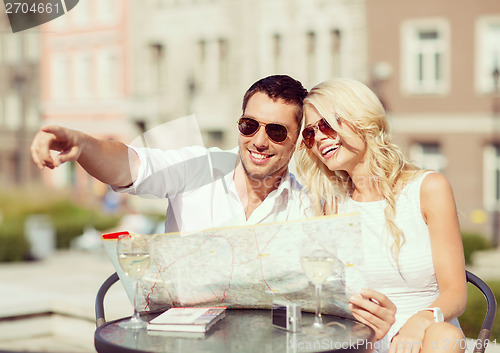 Image of couple with map in cafe