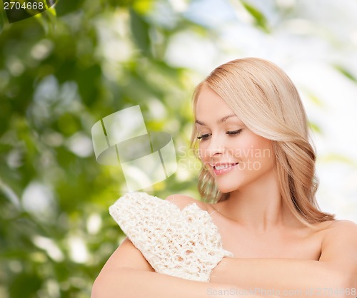 Image of smiling woman with exfoliation glove