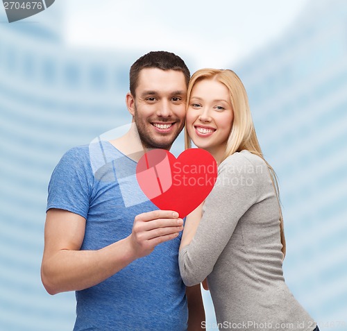 Image of smiling couple holding big red heart