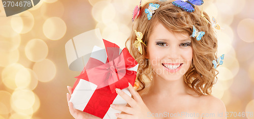 Image of teenager with butterflies in hair showing present