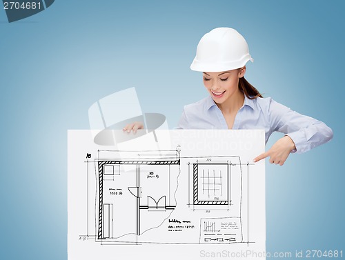 Image of businesswoman in helmet pointing finger to board