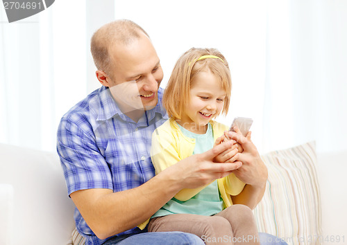 Image of happy father and daughter with smartphone