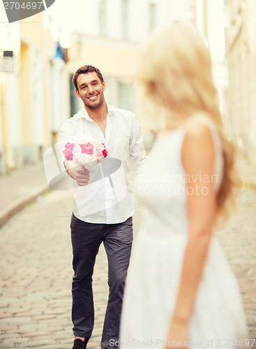 Image of couple with flowers in the city