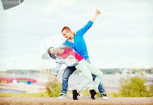 Image of couple of teenagers dancing outside