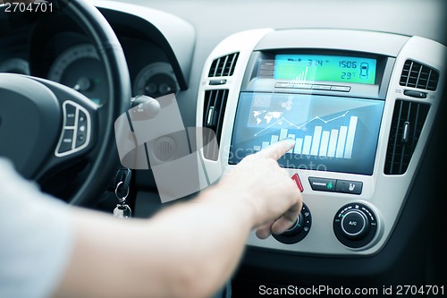 Image of man using car control panel