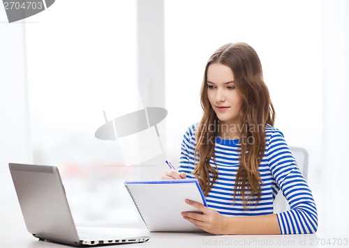 Image of teenage girl laptop computer and notebook