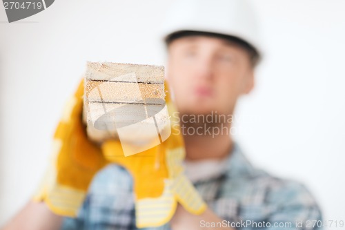 Image of close up of male in gloves carrying wooden boards