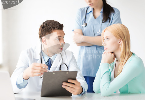 Image of male doctor with patient