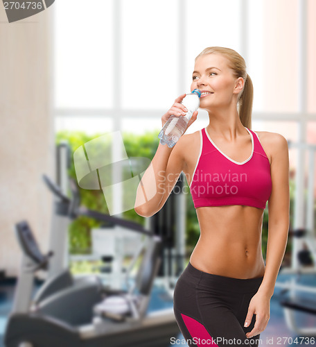 Image of smiling woman with bottle of water