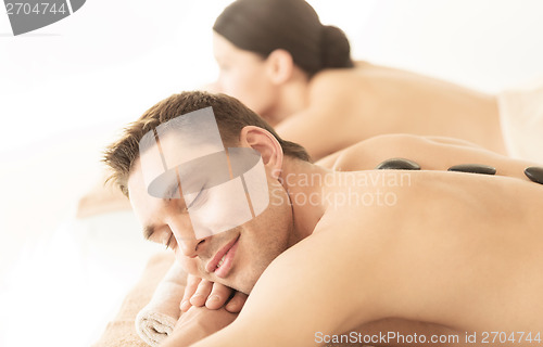 Image of couple in spa with hot stones