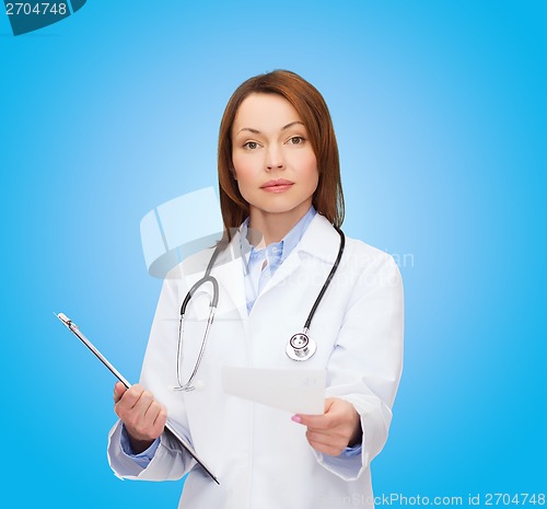 Image of calm female doctor with clipboard