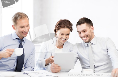 Image of business team having fun with tablet pc in office