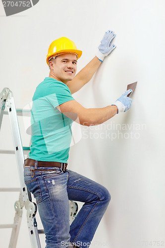 Image of smiling man in helmet doing renovations at home