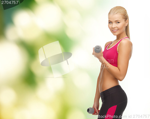 Image of young sporty woman with light dumbbells