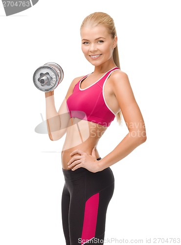 Image of smiling woman with heavy steel dumbbell