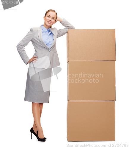 Image of smiling businesswoman with cardboard boxes