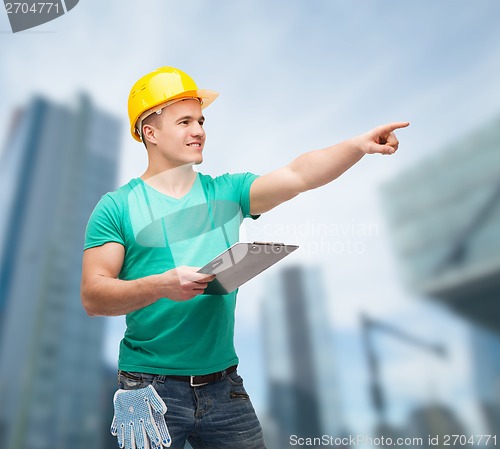 Image of smiling man in helmet with clipboard