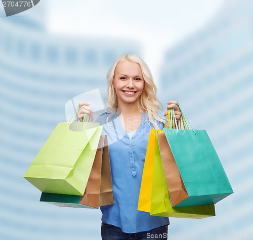 Image of smiling woman with many shopping bags