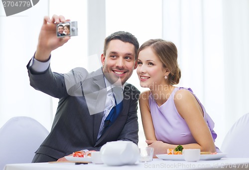 Image of smiling couple taking self portrait picture