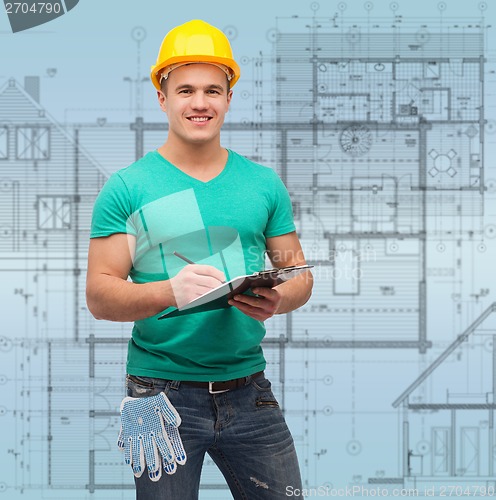 Image of smiling man in helmet with clipboard