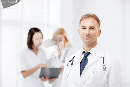 Image of male doctor with colleagues