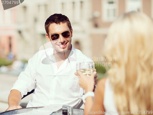 Image of couple drinking wine in cafe