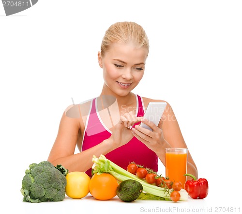 Image of woman with vegetables pointing at smartphone