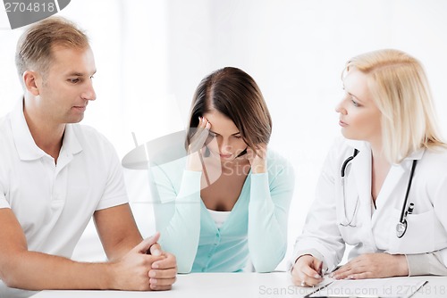 Image of doctor with patients in cabinet