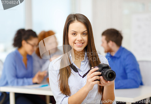 Image of smiling female photographer with photocamera