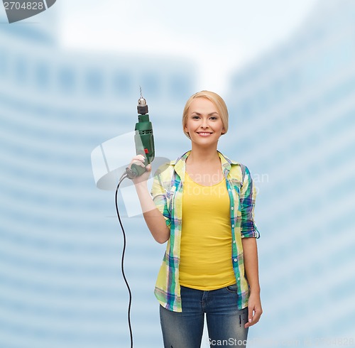 Image of smiling woman with drill machine