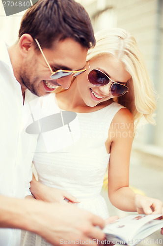 Image of couple with tourist book in the city