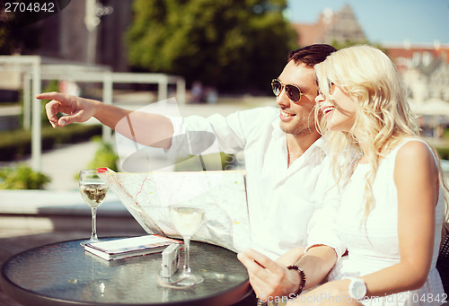 Image of couple with map in cafe