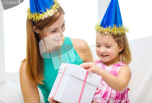 Image of mother and daughter in blue hats with gift box