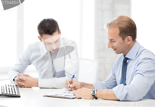 Image of businessmen with notebook on meeting