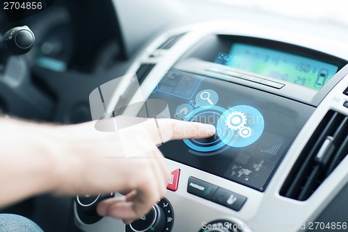 Image of man using car control panel