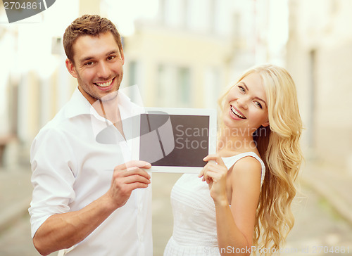 Image of couple with tablet pc in the city