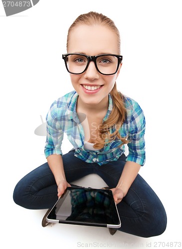 Image of smiling woman sitiing on floor with tablet pc