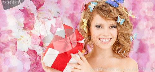 Image of teenager with butterflies in hair showing present