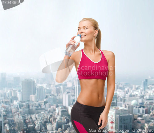 Image of smiling woman with bottle of water