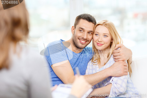 Image of young couple hugging at psychologist office