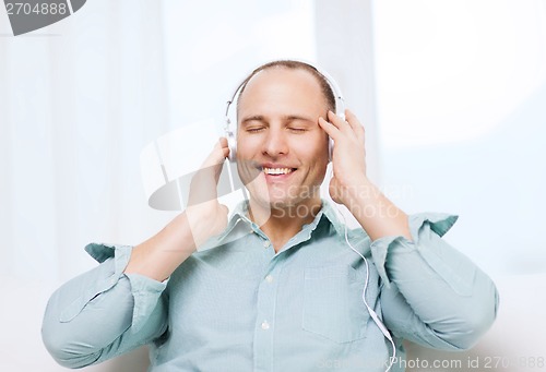 Image of smiling man with headphones listening to music