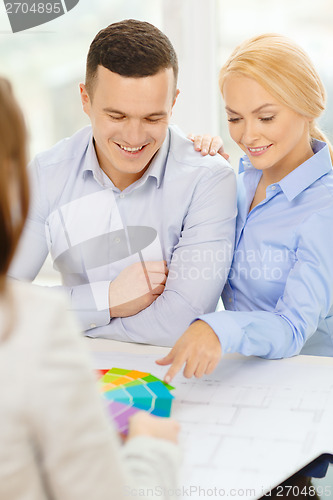 Image of couple looking at blueprint and color samples