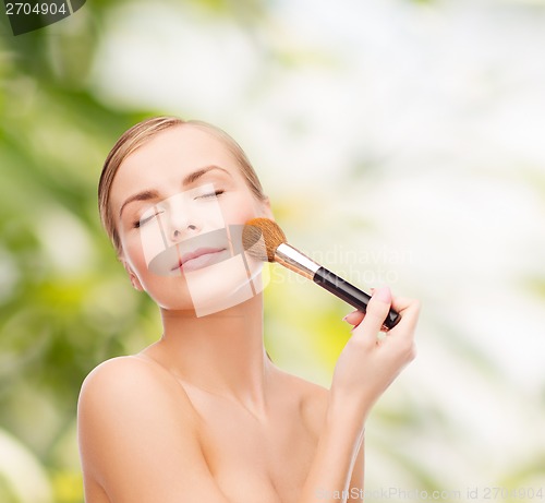 Image of beautiful woman with makeup brush