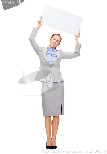 Image of smiling businesswoman with white blank board